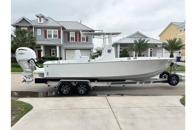 The Image of 2021 Latitude Tournament Boats 25 on trailer, parked in residential area. - 0