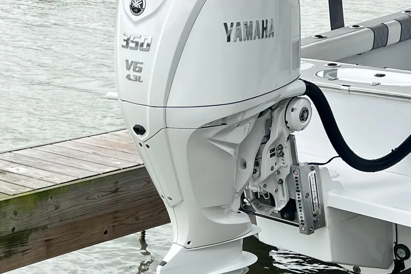Slide: The Image of Yamaha 350 V6 outboard motor on 2021 Latitude Tournament Boats 25, docked by water. - 1