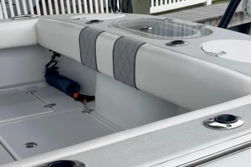 Slide: The Image of 2021 Latitude Tournament Boats 25 interior with seating and storage compartments. - 11