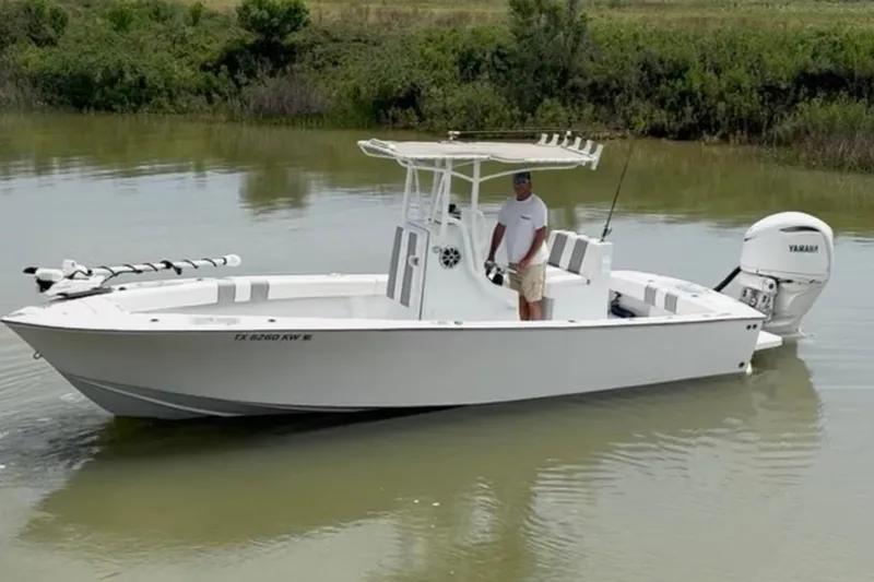 Slide: The Image of 2021 Latitude Tournament Boats 25 in calm water, featuring a Yamaha outboard motor. - 12