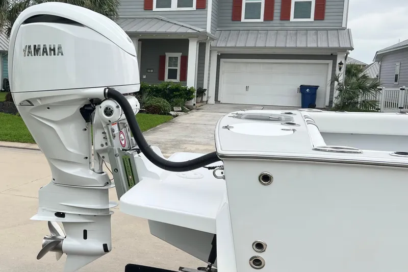 Slide: The Image of 2021 Latitude Tournament Boats 25 with Yamaha outboard motor in residential driveway. - 2