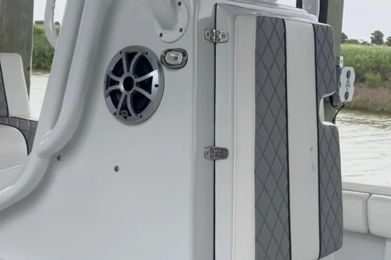 Slide: The Image of 2021 Latitude Tournament Boats 25 interior with speaker and cushioned seating. - 9