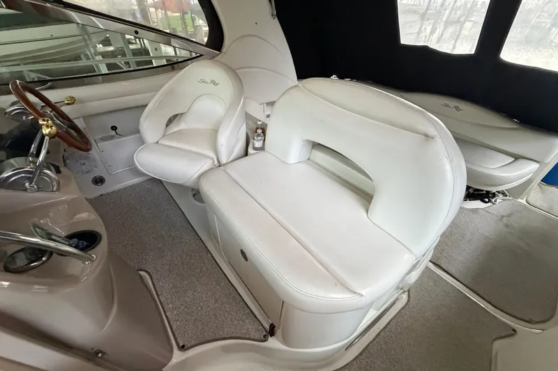 Slide: The Image of 2002 Sea Ray 360 Sundancer cockpit with white leather seating and steering wheel. - 10