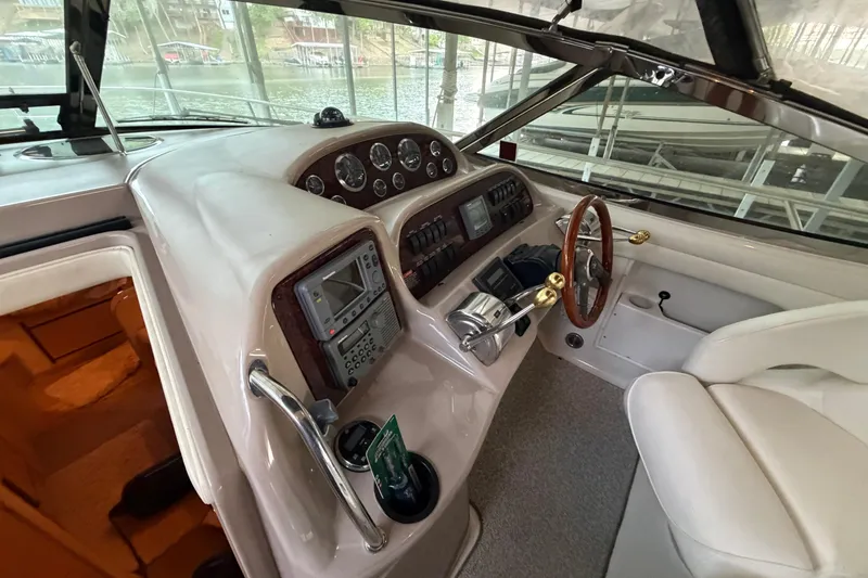 Slide: The Image of Cockpit of 2002 Sea Ray 360 Sundancer with steering wheel and control panel. - 12