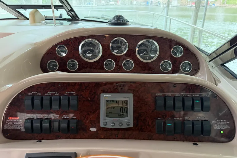 Slide: The Image of Dashboard of a 2002 Sea Ray 360 Sundancer boat with gauges and controls. - 14