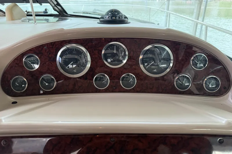 Slide: The Image of Dashboard of a 2002 Sea Ray 360 Sundancer boat with multiple gauges. - 17