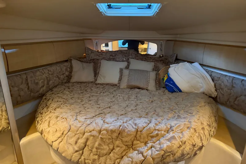 Slide: The Image of Luxurious cabin interior of 2002 Sea Ray 360 Sundancer with plush bedding. - 22