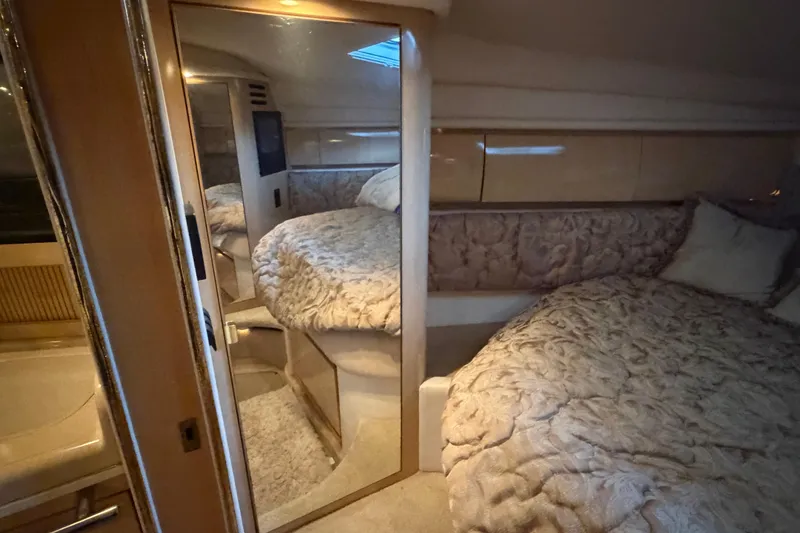 Slide: The Image of Luxurious interior of 2002 Sea Ray 360 Sundancer yacht with plush bedding and mirrored closet. - 23