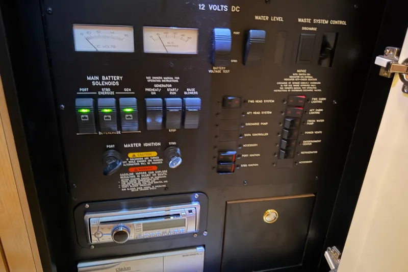 Slide: The Image of Control panel of a 2002 Sea Ray 360 Sundancer boat with various switches and gauges. - 29