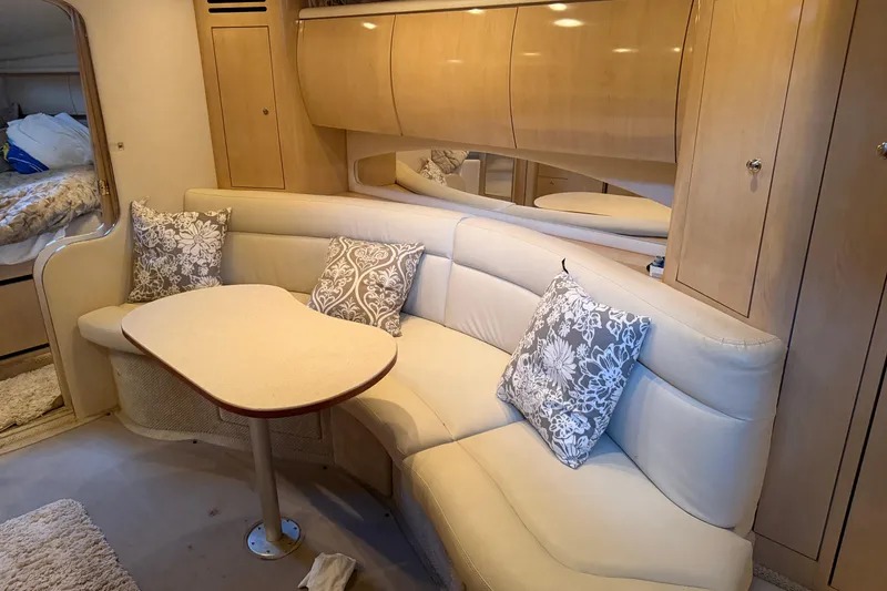 Slide: The Image of Interior of 2002 Sea Ray 360 Sundancer with beige seating and floral pillows. - 31