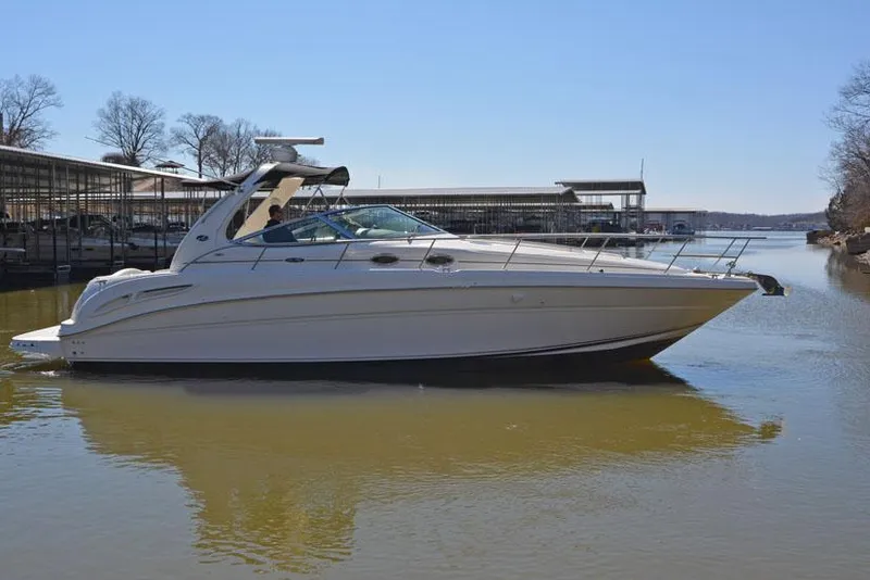 Slide: The Image of 2002 Sea Ray 360 Sundancer on calm water near docks. - 4