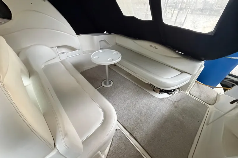Slide: The Image of Interior of 2002 Sea Ray 360 Sundancer with white seating and small table. - 6