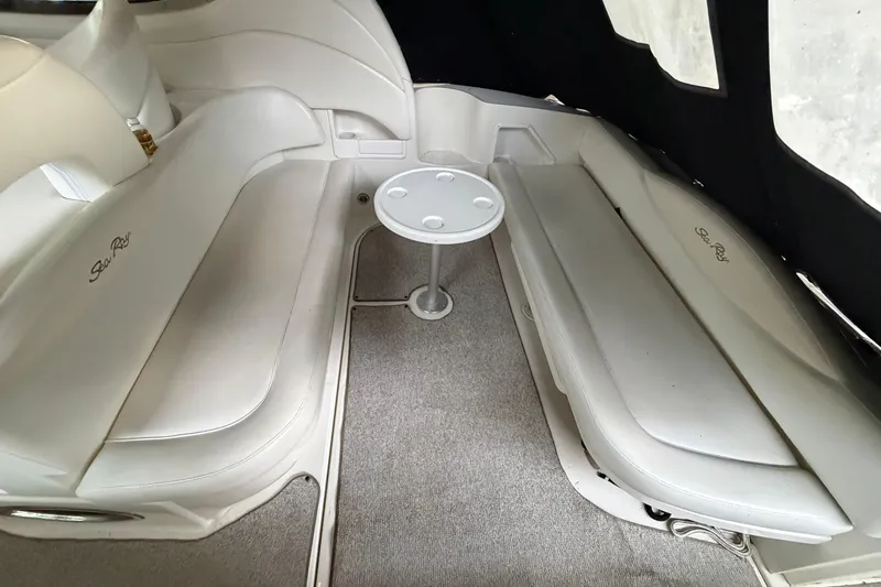 Slide: The Image of Interior of 2002 Sea Ray 360 Sundancer with white seating and small round table. - 7