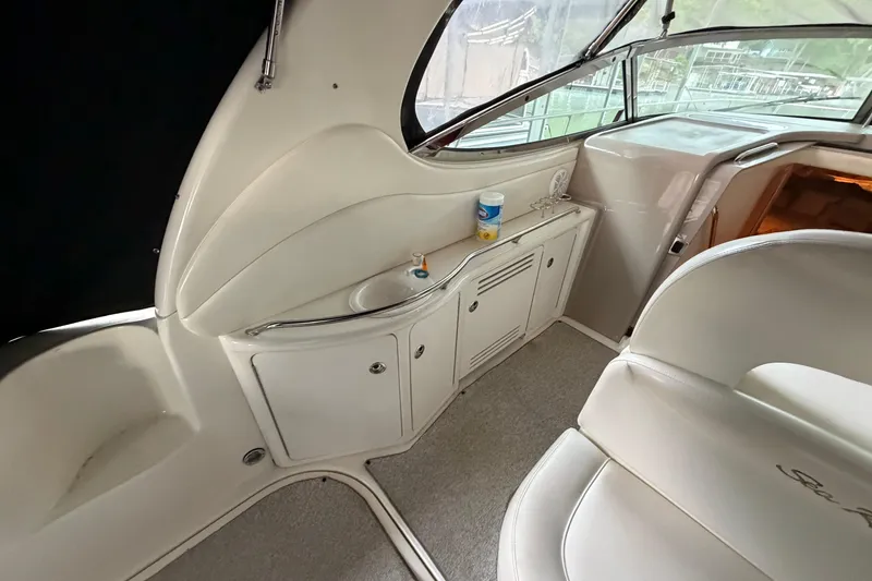 Slide: The Image of Interior of 2002 Sea Ray 360 Sundancer yacht with seating and storage area. - 9
