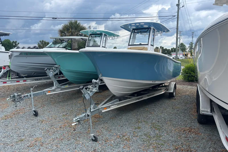 The Image of 2025 Sportsman Heritage 231 Center Console boat on trailer, displayed outdoors. - 0