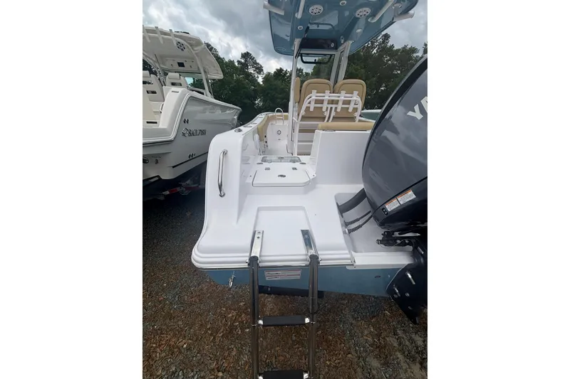 Slide: The Image of 2025 Sportsman Heritage 231 Center Console boat with ladder and outboard motor. - 3