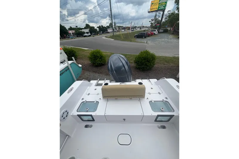 Slide: The Image of 2025 Sportsman Heritage 231 Center Console boat, rear view with seating and storage compartments. - 4