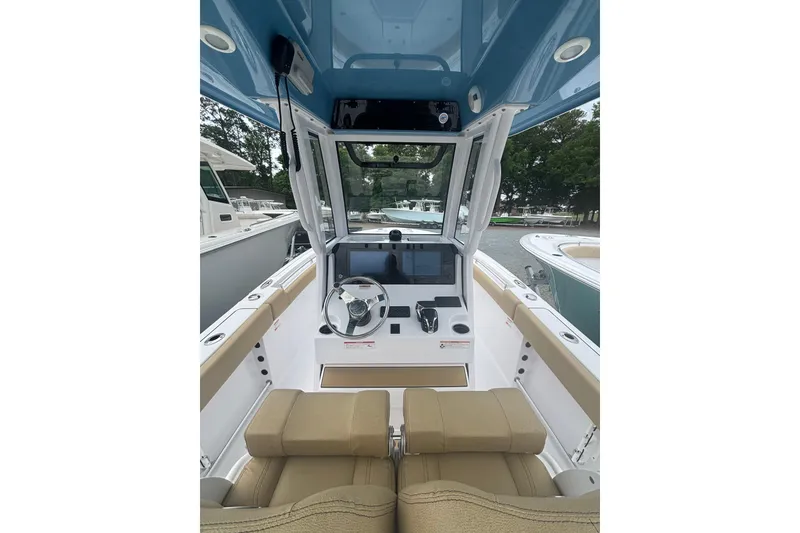 Slide: The Image of 2025 Sportsman Heritage 231 Center Console boat interior with modern helm and seating. - 5