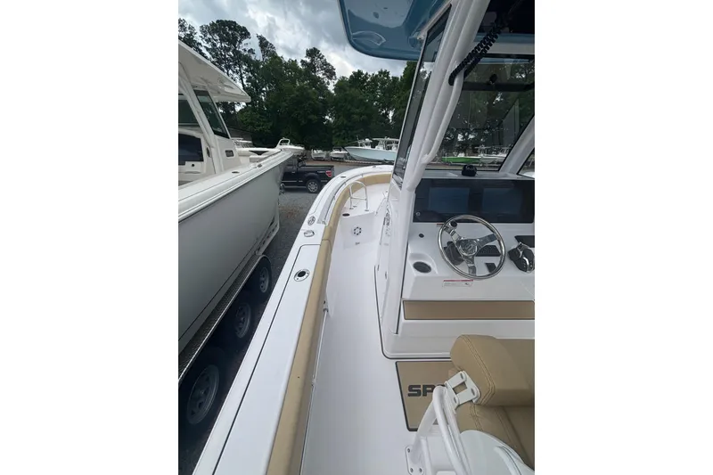 Slide: The Image of 2025 Sportsman Heritage 231 Center Console boat interior with steering wheel and seating. - 7