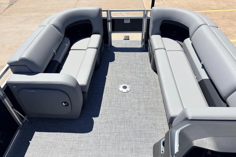 Slide: The Image of 2026 Sun Tracker SportFish 22 DLX pontoon boat interior with gray seating and spacious layout. - 10
