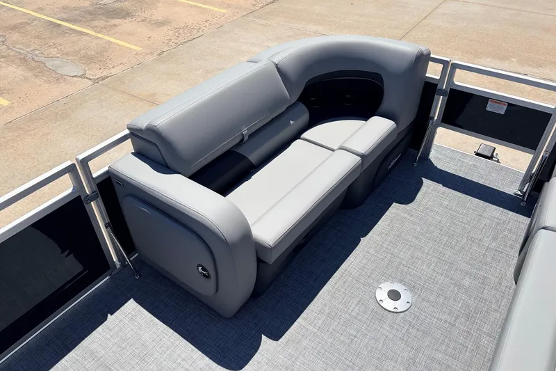 Slide: The Image of 2026 Sun Tracker SportFish 22 DLX pontoon boat with gray seating and spacious deck. - 11