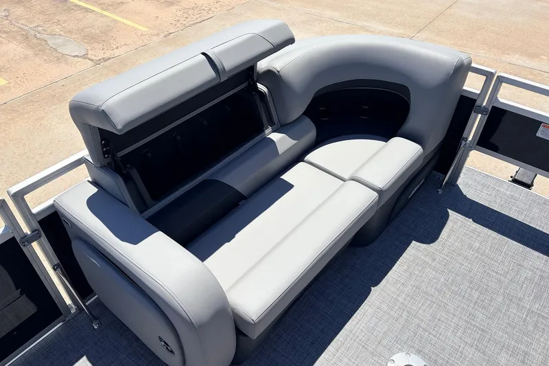 Slide: The Image of 2026 Sun Tracker SportFish 22 DLX boat with gray cushioned seating and storage compartment. - 12
