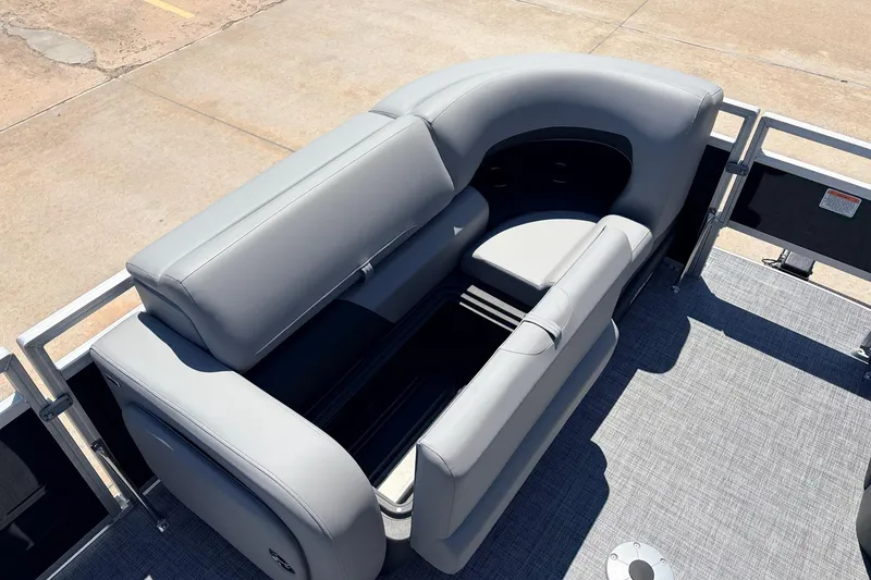 Slide: The Image of 2026 Sun Tracker SportFish 22 DLX boat interior with gray seating and storage compartments. - 13