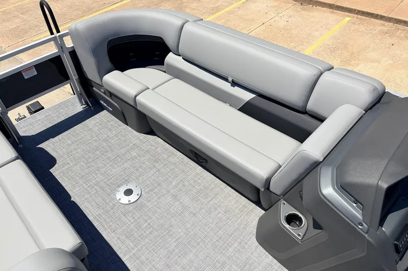 Slide: The Image of 2026 Sun Tracker SportFish 22 DLX boat interior with gray seating and flooring. - 18