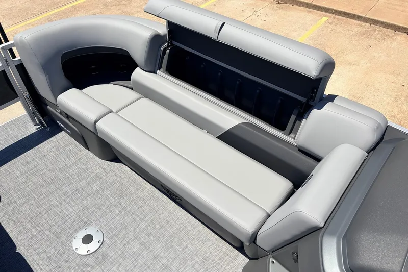 Slide: The Image of 2026 Sun Tracker SportFish 22 DLX boat interior with gray seating and storage compartment. - 19
