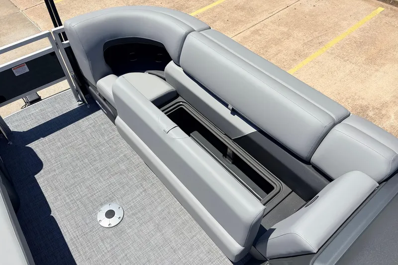 Slide: The Image of 2026 Sun Tracker SportFish 22 DLX boat interior with gray seating and storage compartment. - 20