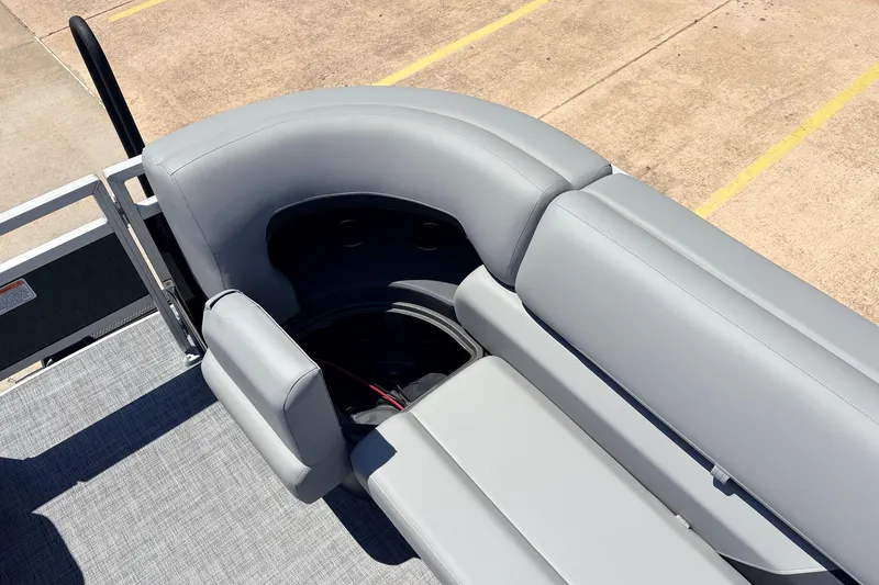Slide: The Image of 2026 Sun Tracker SportFish 22 DLX boat seating with gray upholstery and storage compartment. - 21