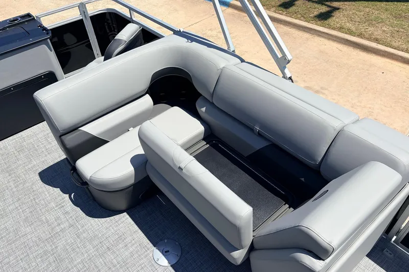 Slide: The Image of 2026 Sun Tracker SportFish 22 DLX boat interior with gray seating and storage. - 28