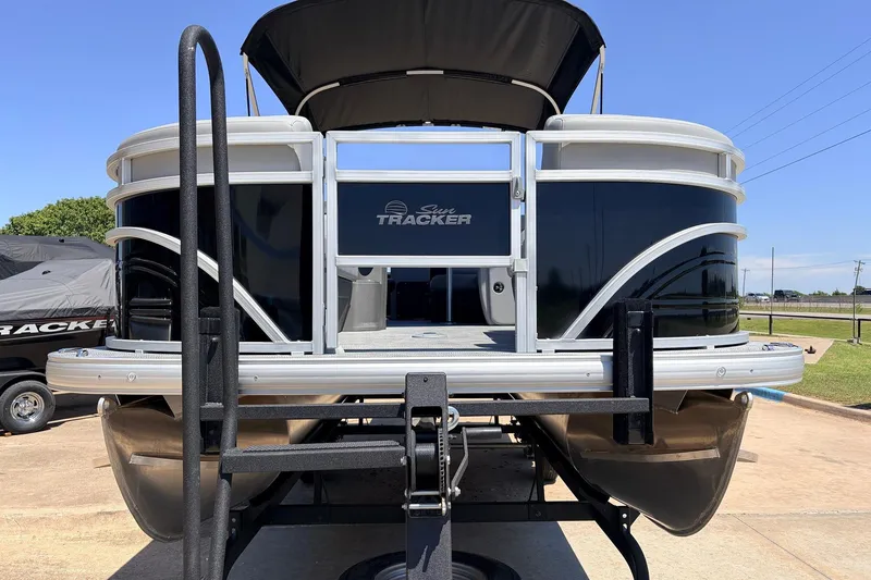 Slide: The Image of 2026 Sun Tracker SportFish 22 DLX pontoon boat on trailer, front view. - 3