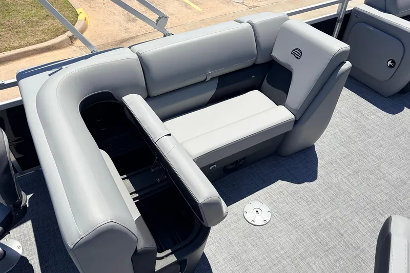 Slide: The Image of 2026 Sun Tracker SportFish 22 DLX boat interior with gray seating and storage compartment. - 30