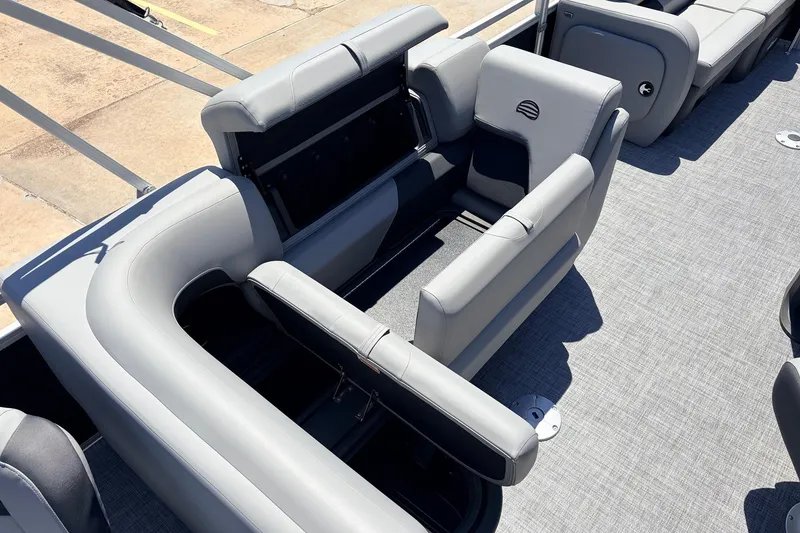 Slide: The Image of 2026 Sun Tracker SportFish 22 DLX boat interior with gray seating and storage compartments. - 31