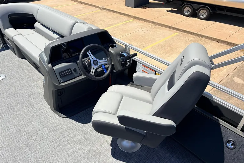 Slide: The Image of 2026 Sun Tracker SportFish 22 DLX boat interior with steering wheel and seating. - 32