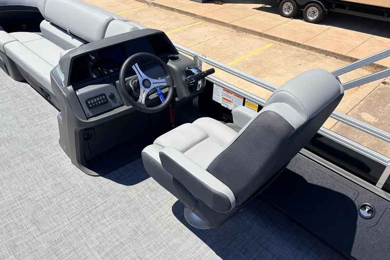 Slide: The Image of 2026 Sun Tracker SportFish 22 DLX boat interior with steering wheel and seating. - 33