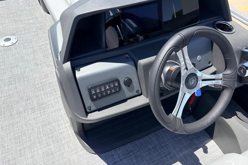 Slide: The Image of 2026 Sun Tracker SportFish 22 DLX dashboard with steering wheel and control panel. - 34