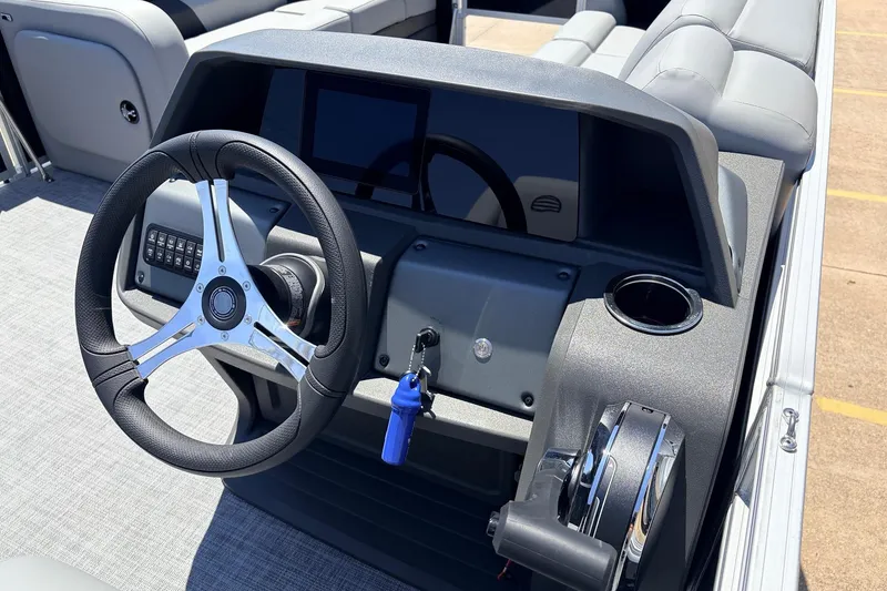 Slide: The Image of 2026 Sun Tracker SportFish 22 DLX boat dashboard with steering wheel and controls. - 35
