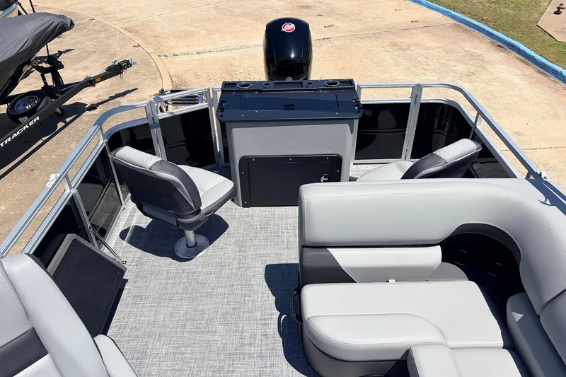 Slide: The Image of 2026 Sun Tracker SportFish 22 DLX pontoon boat interior with seating and helm. - 37