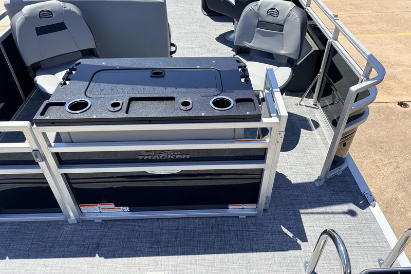 Slide: The Image of 2026 Sun Tracker SportFish 22 DLX pontoon boat interior with seating and fishing station. - 42