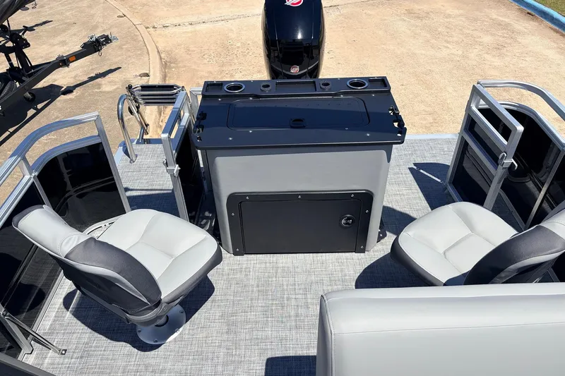 Slide: The Image of 2026 Sun Tracker SportFish 22 DLX pontoon boat interior with seating and helm station. - 43