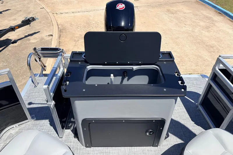Slide: The Image of 2026 Sun Tracker SportFish 22 DLX boat interior with sink and storage area. - 45