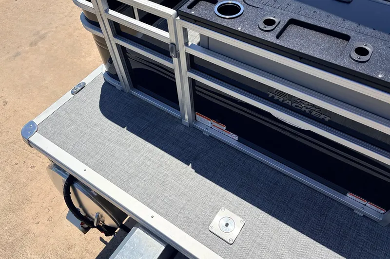 Slide: The Image of 2026 Sun Tracker SportFish 22 DLX boat deck with railing and storage compartments. - 47