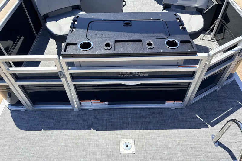 Slide: The Image of 2026 Sun Tracker SportFish 22 DLX pontoon boat interior with seating and storage. - 48