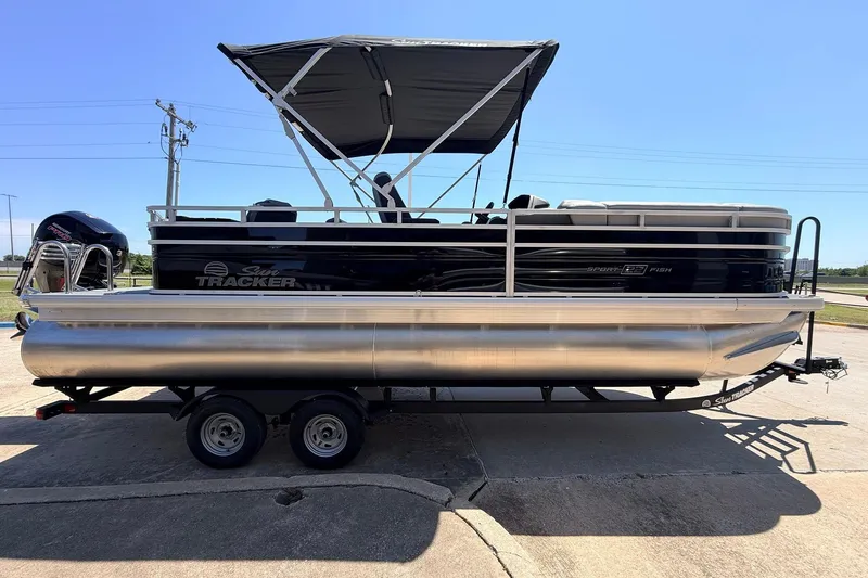 Slide: The Image of 2026 Sun Tracker SportFish 22 DLX pontoon boat on trailer, featuring a canopy. - 5