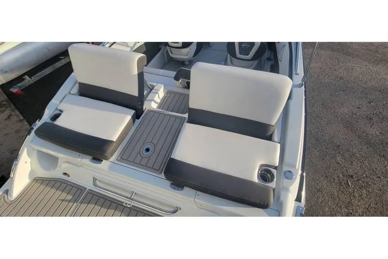 Slide: The Image of 2024 Crownline 210 SS boat interior with dual seats and cup holders. - 11