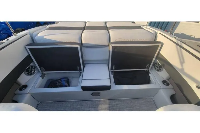 Slide: The Image of 2024 Crownline 210 SS boat interior with open storage compartments and cushioned seating. - 12