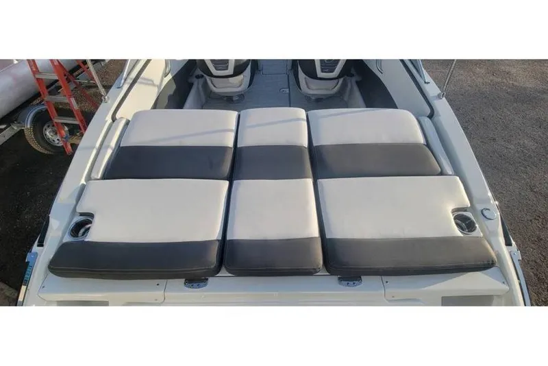 Slide: The Image of 2024 Crownline 210 SS boat with cushioned seating and cup holders, viewed from above. - 13