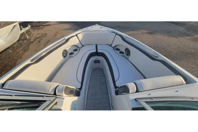 Slide: The Image of 2024 Crownline 210 SS boat interior with cushioned seating and built-in speakers. - 15